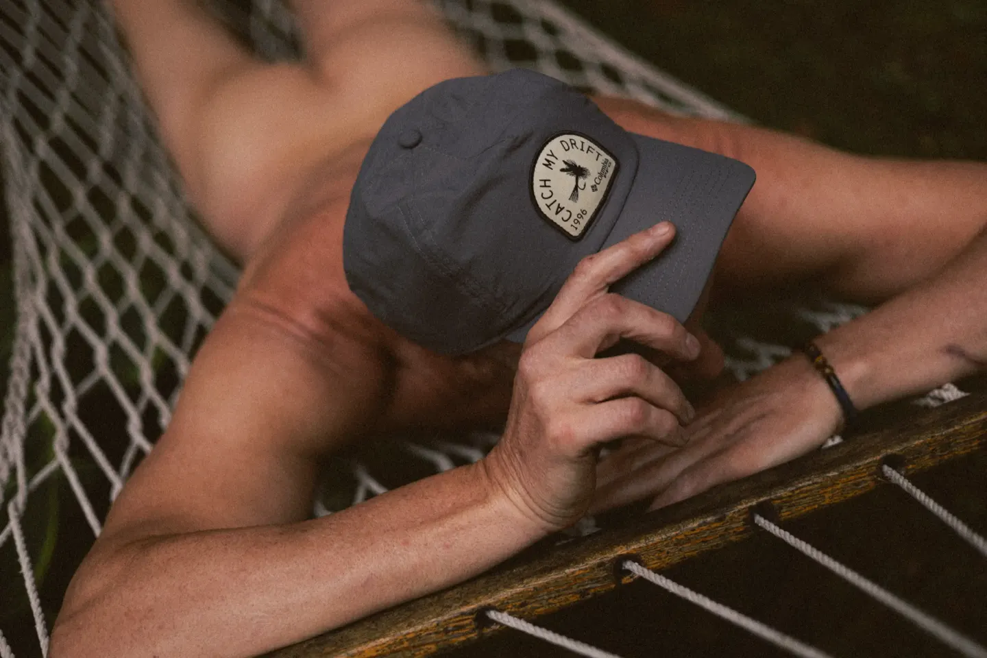 Homme torse nu dans un hamac, casquette sur le visage — séance boudoir lifestyle Belle Tronche